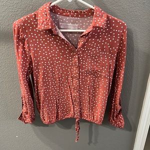Burnt orange with white polka dots button up blouse.